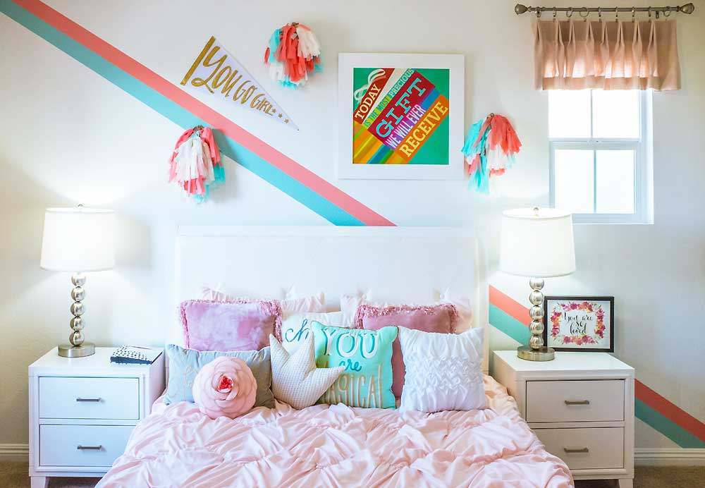 kids room with pink bed and multiple throw pillows