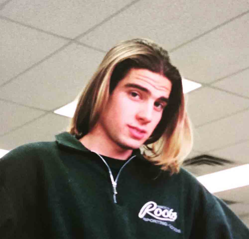 A young Scott McGillivray with long straight blow-dried hair.
