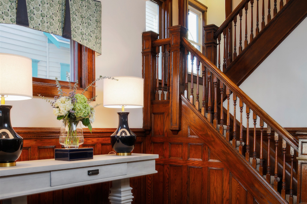 Large and beautiful wood staircase featuring wood side paneling.