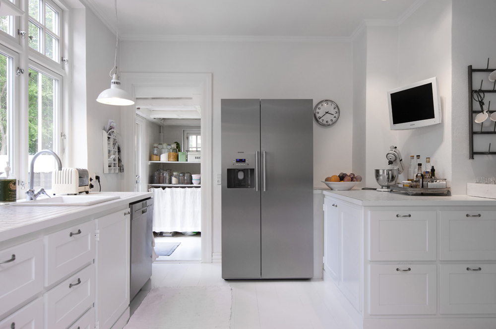 White kitchen with silver upright fridge