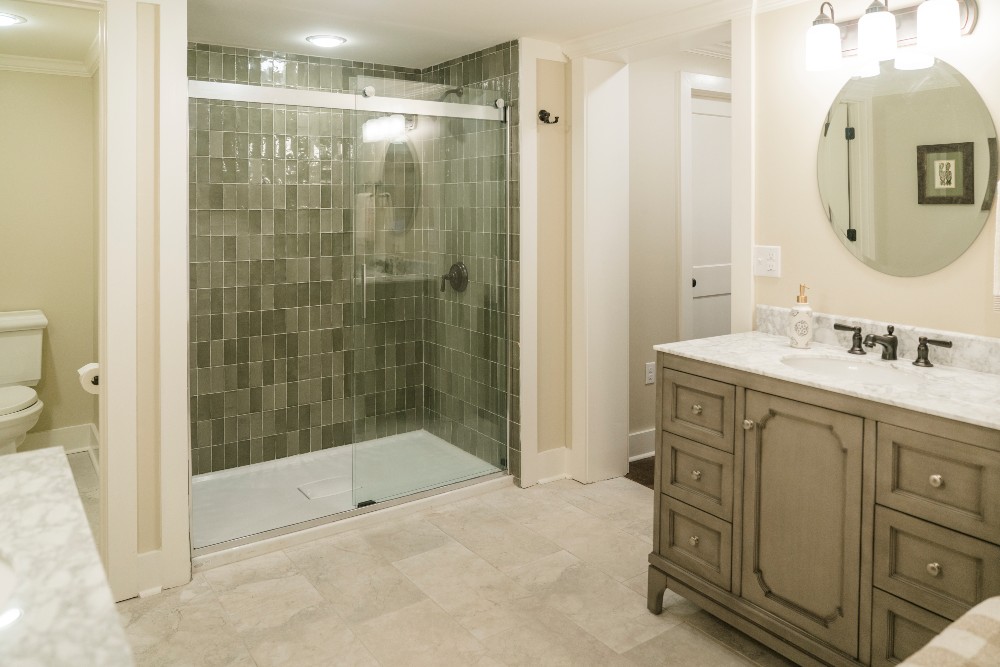 Primary bathroom with green tiled shower