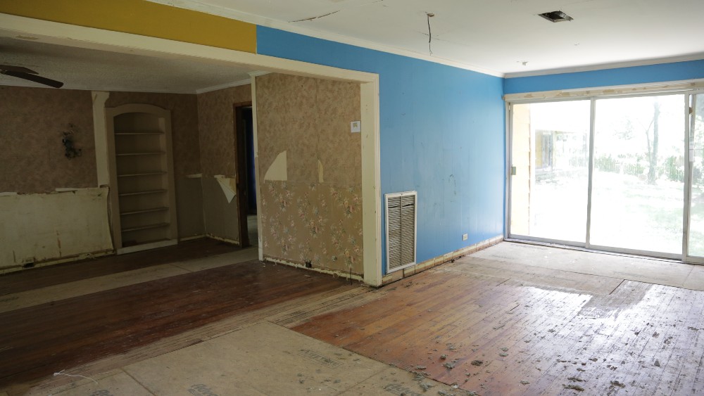 Abandoned living room with yellow and blue walls
