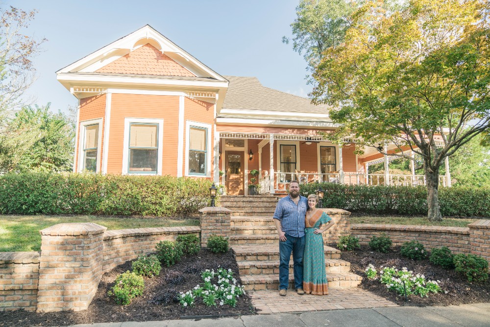 Ben and Erin Napier standing in front of 100-year-old home