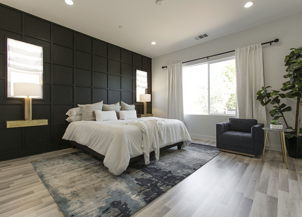 Beautifully designed master bedroom with dark accent wall