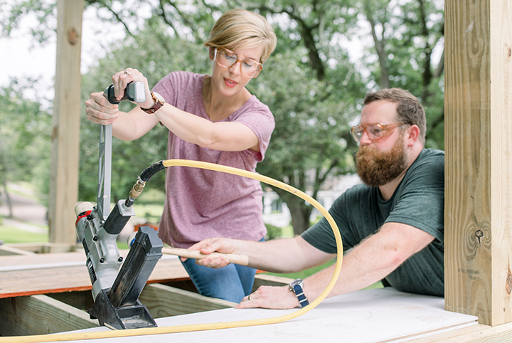 Ben and Erin Napier work on a frame of a house