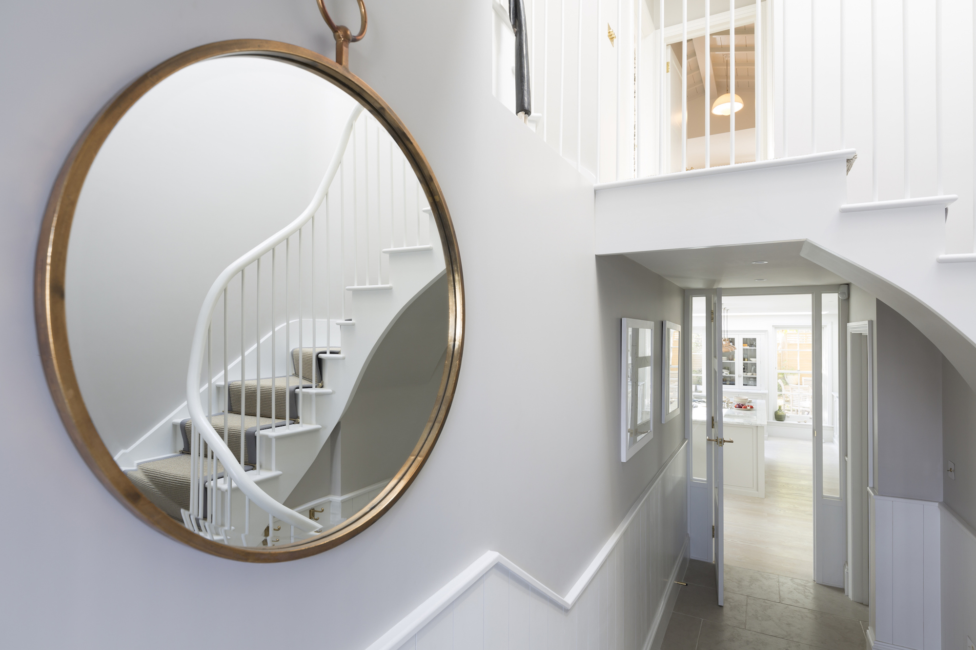 Large round mirror in the hallway of a home
