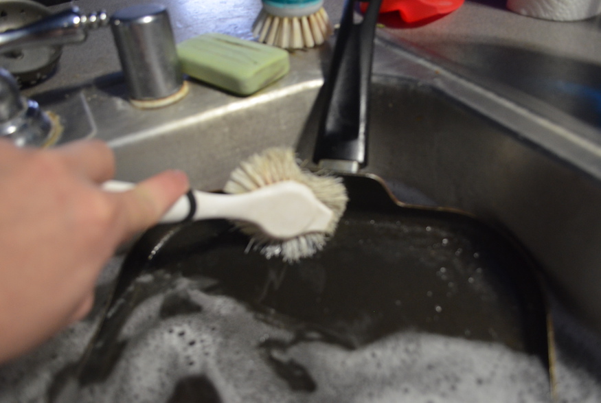 Scrubbing a pan in the sink