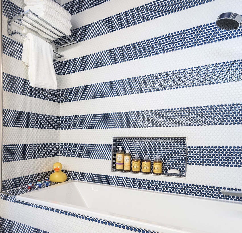 Kids' bathroom with blue and white penny-round tile.