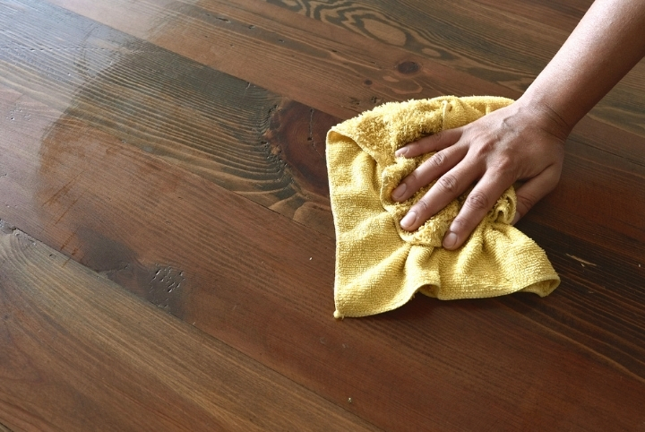 Person wiping yellow microfiber cloth