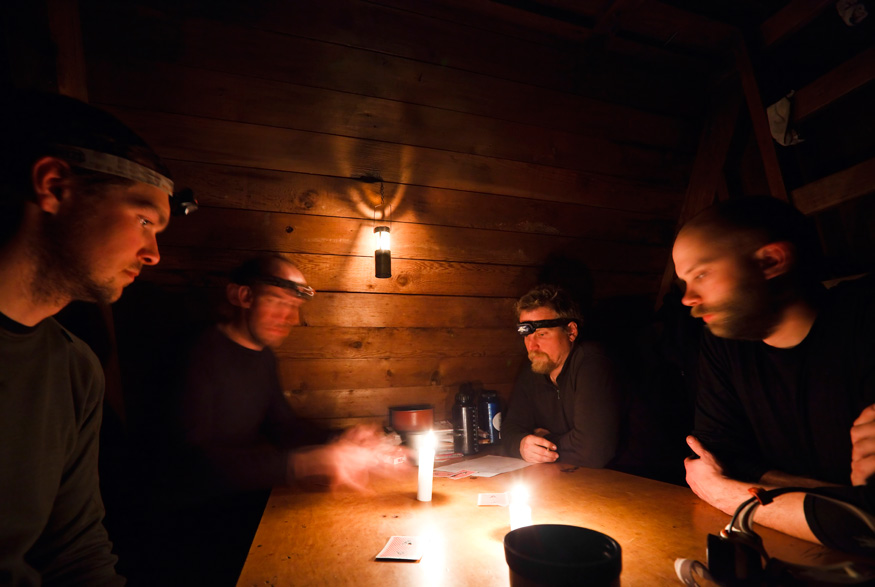 People playing games by candlelight