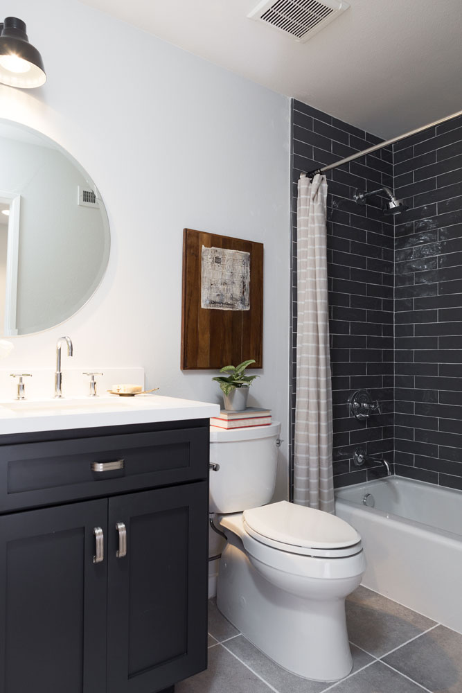 Black brick tile and a coordinating vanity give attitude to this bathroom.