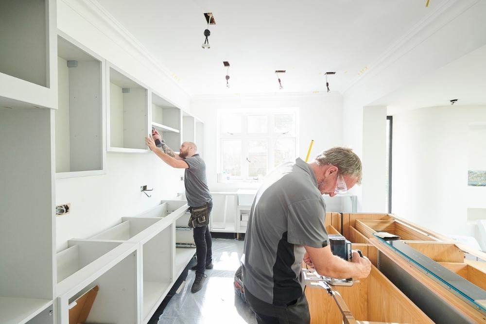 Two contractors working on a kitchen renovation