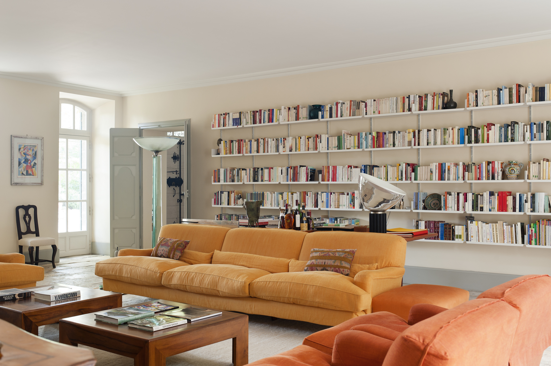 Wall-mounted shelving system for books and seating area