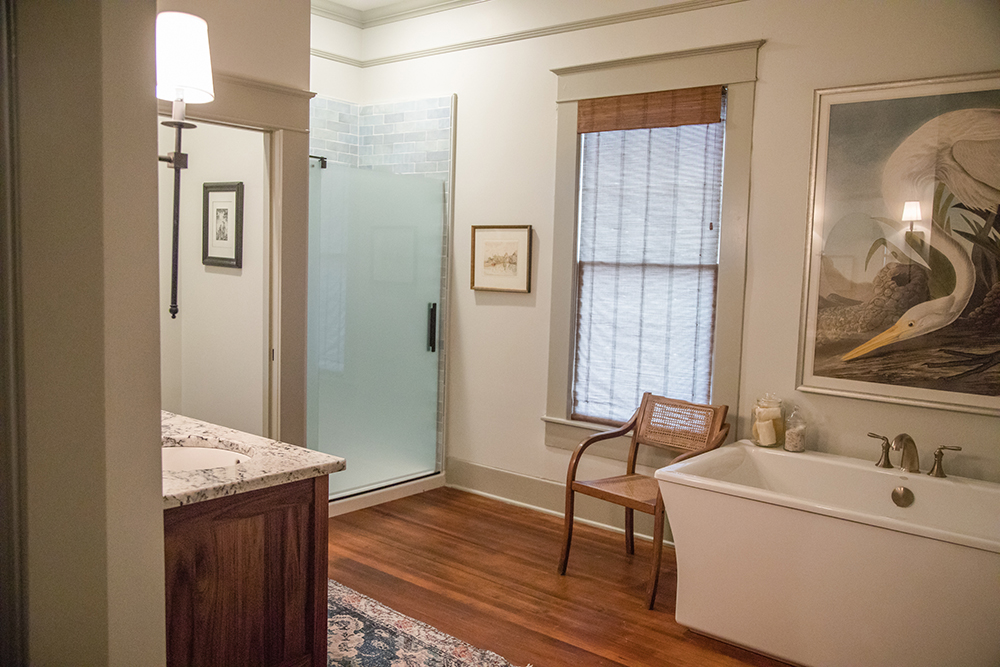 A spacious primary bathroom with a soaker tub