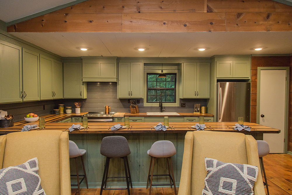 Moss green cabinets with an extra long kitchen island