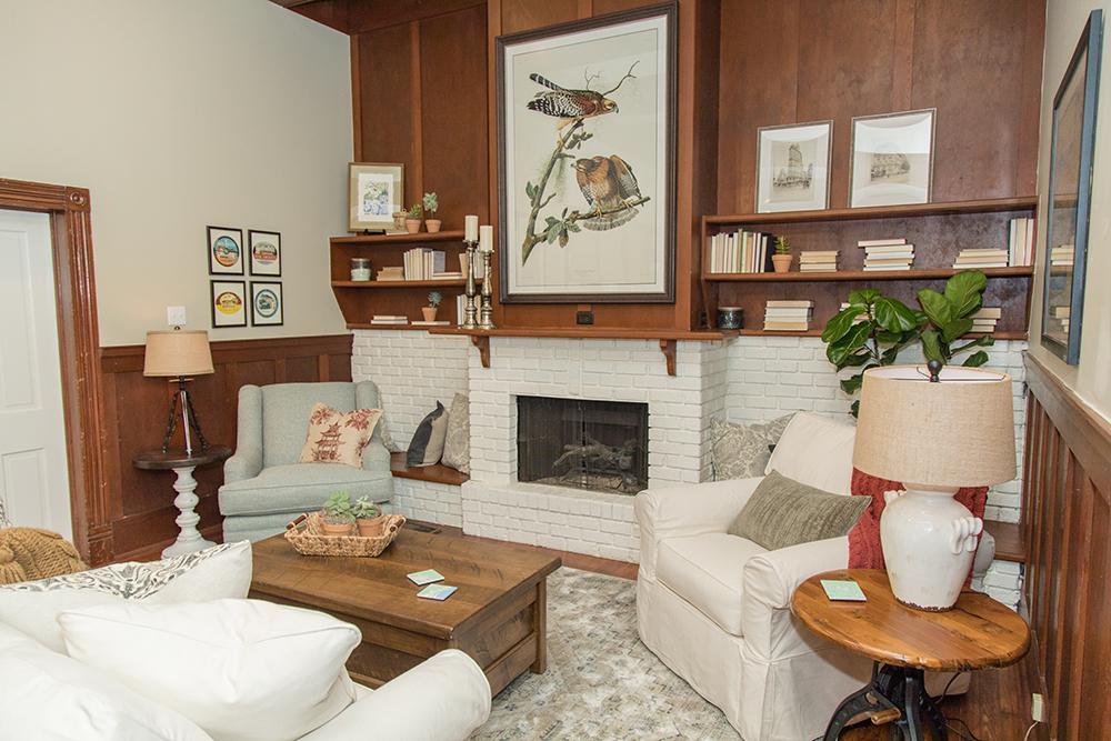 Family room with a painted white fireplace