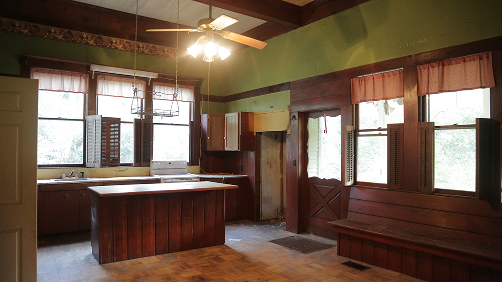 A dated brown and green kitchen