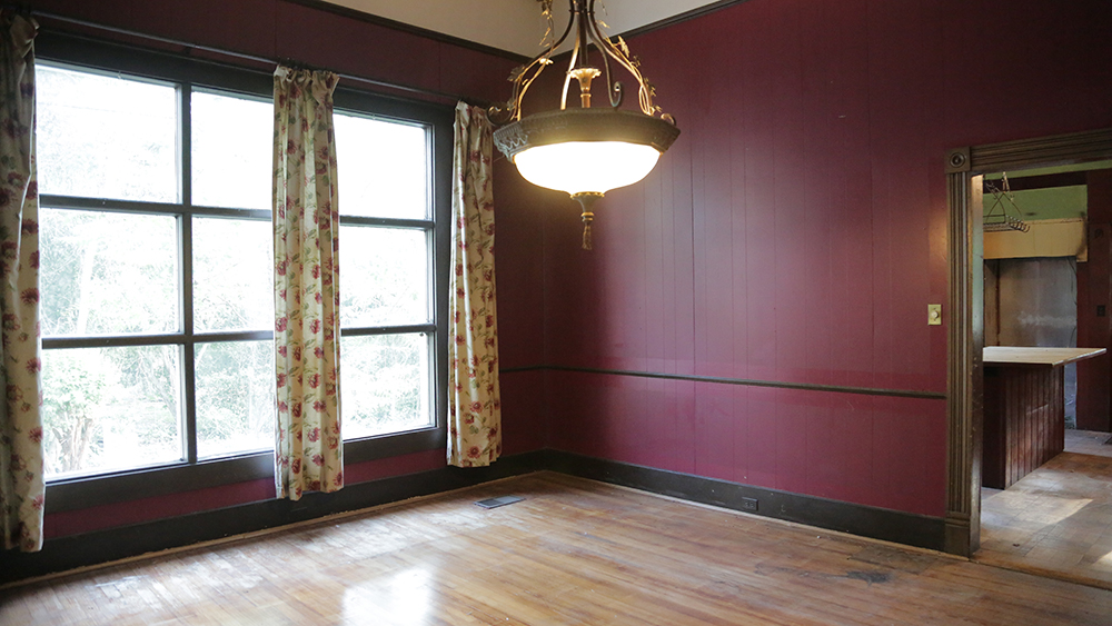 A dining room with plum walls