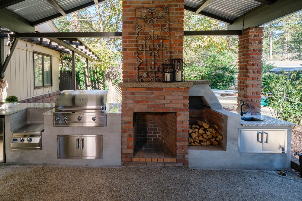 Outdoor kitchen with a grill, hearth and sink