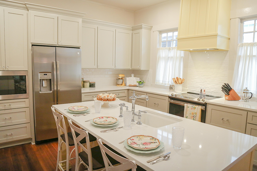 A modern kitchen with daisy yellow cabinetry and a large island