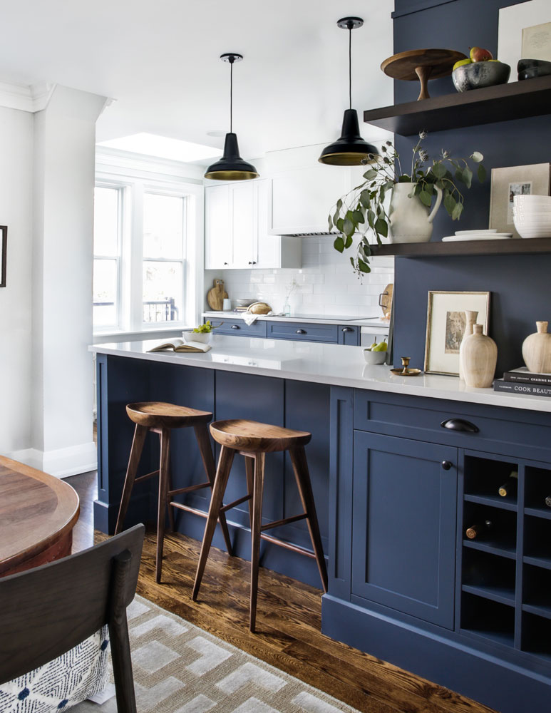 Rustic and modern kitchen with blue cabinetry and wood accents.
