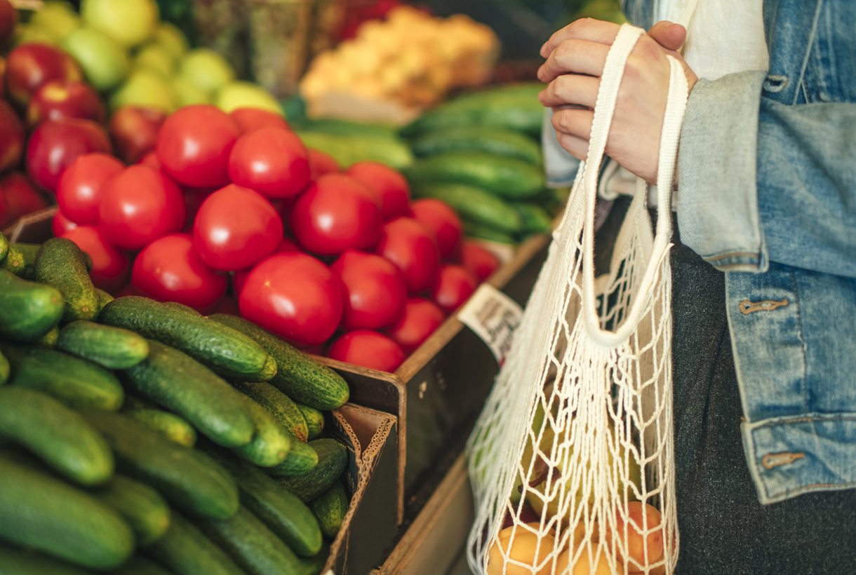 shopping for produce with a reusable bag