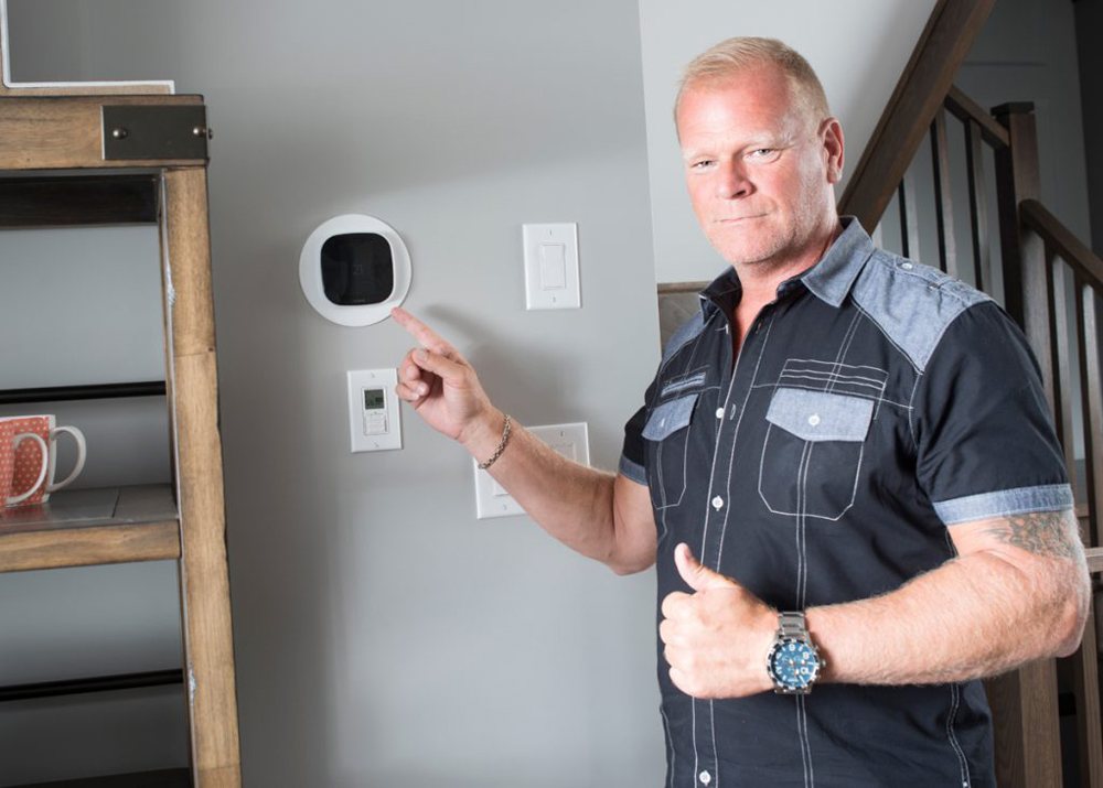 Mike Holmes with programmable thermostat
