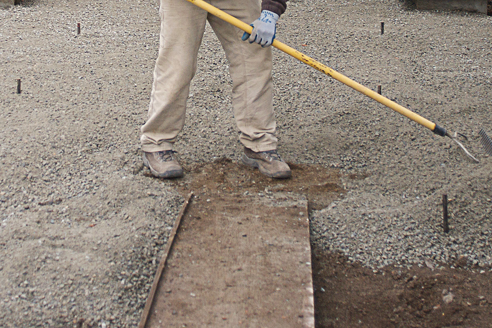 Person installing a gravel floor