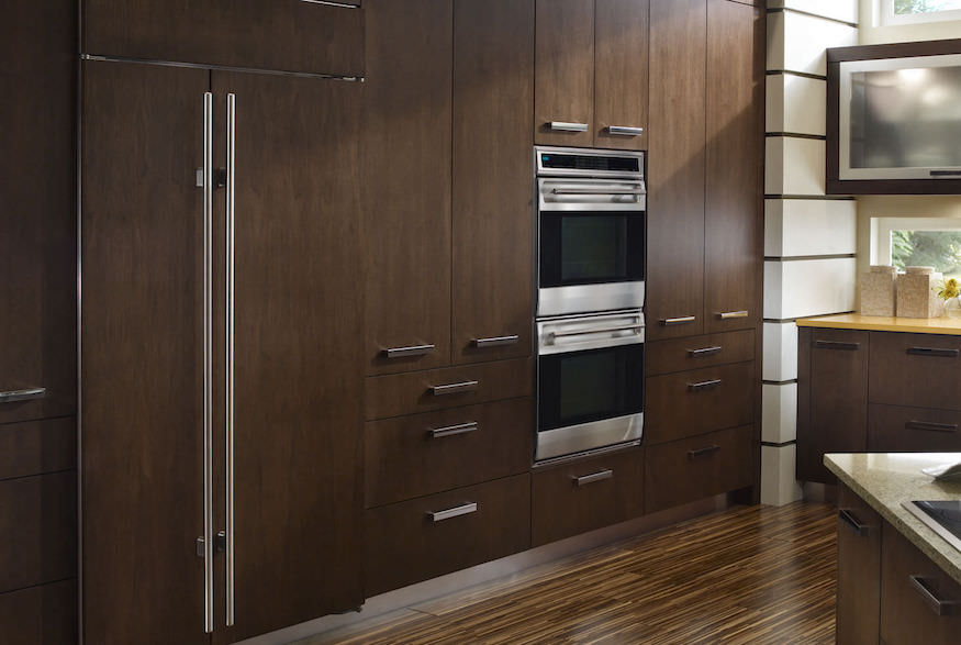 Modern kitchen with wood cabinetry and integrated appliances