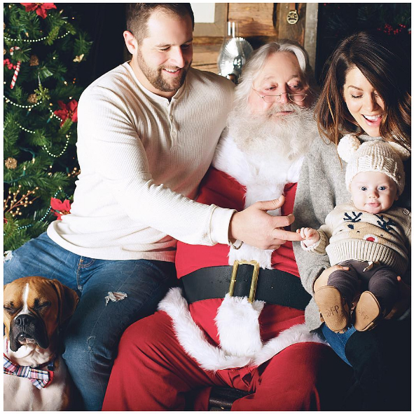 Justin, Jillian Harris and their son Leo sitting on Santa's lap.