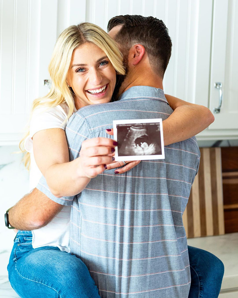 Jasmine Roth with Brett Roth holding an ultrasound photo.