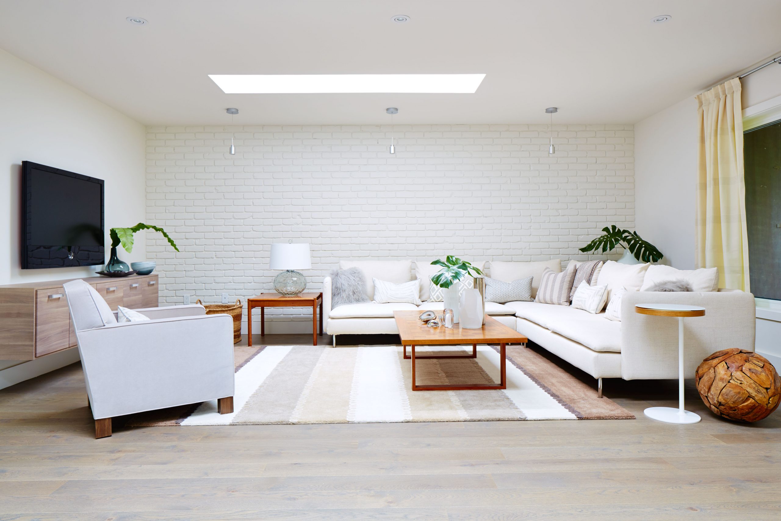 a white living room with streamlined furniture