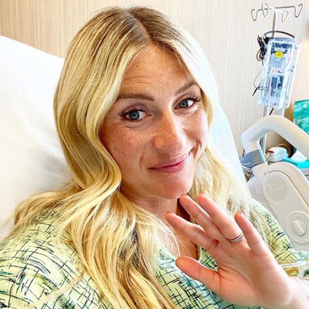 Jasmine Roth smiling in a hospital bed about to give birth.