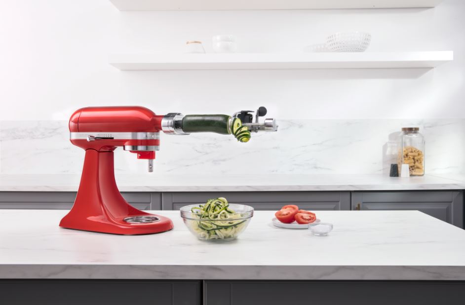 A red KitchenAid Artisan Mini Stand Mixer on a kitchen counter