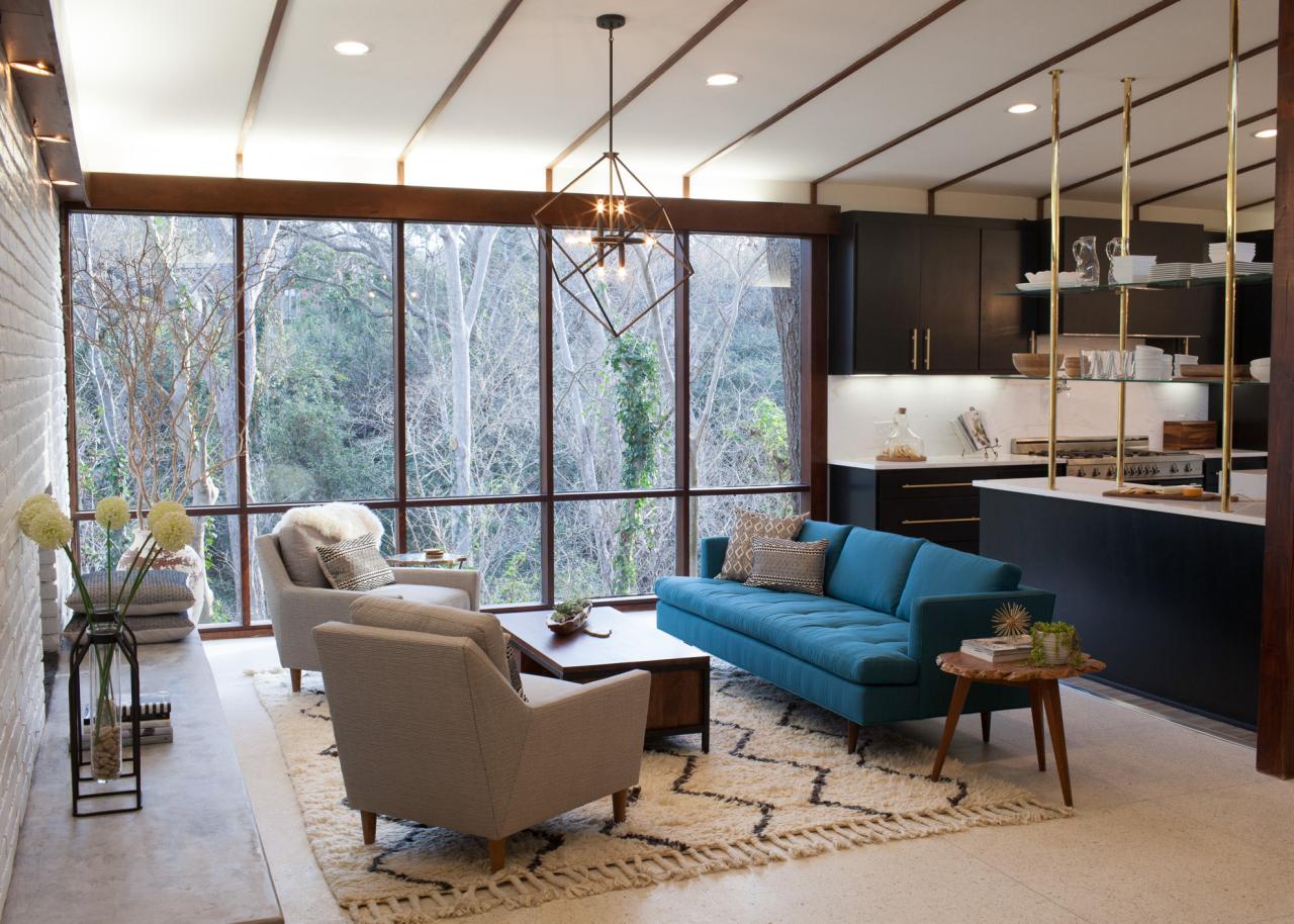 Modern living room with floor-to-ceiling windows showcasing outdoor scenery.