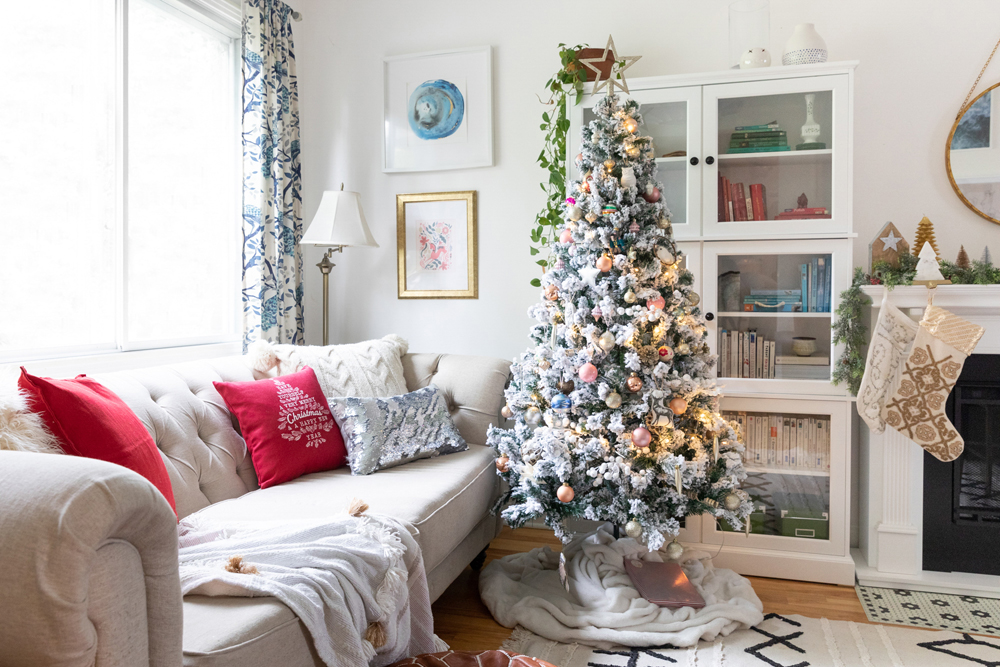 A decorated Christmas tree in the living room of a living room decorated in neutral tones