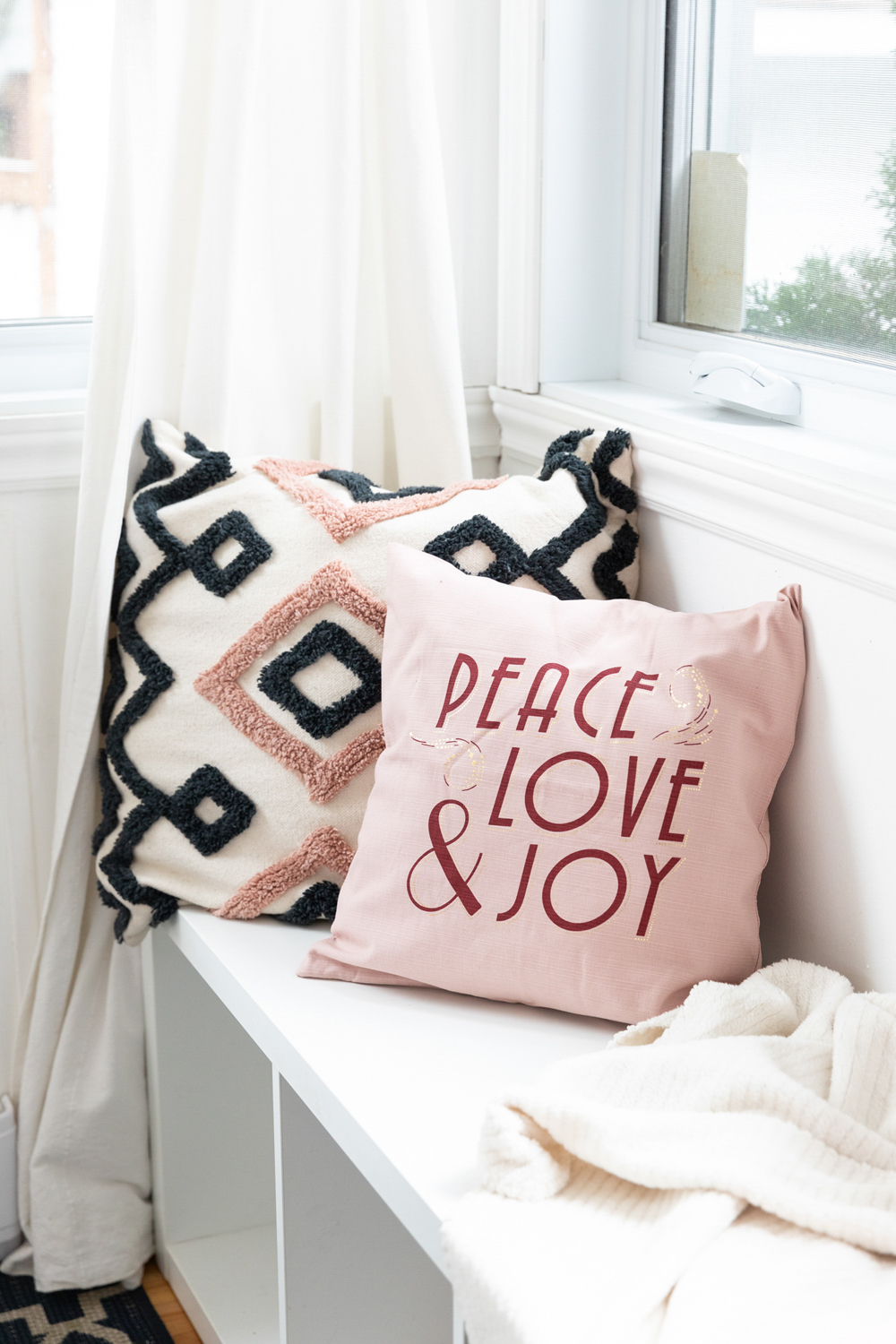 Patterned throw pillows on the bench in the breakfast nook