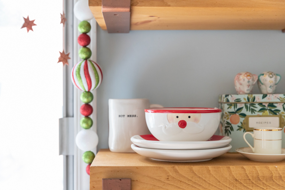 Close-up of holiday-themed bowls and cups, like this Santa mug