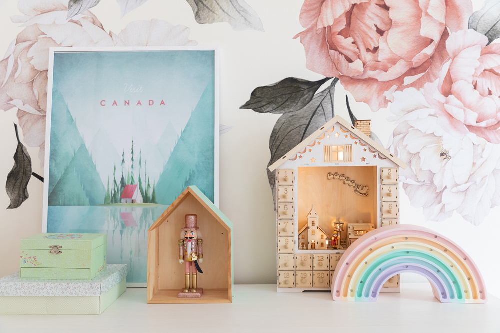 Decor in the kids' bedroom, including a tiny nutcracker and Christmas scene on the side table