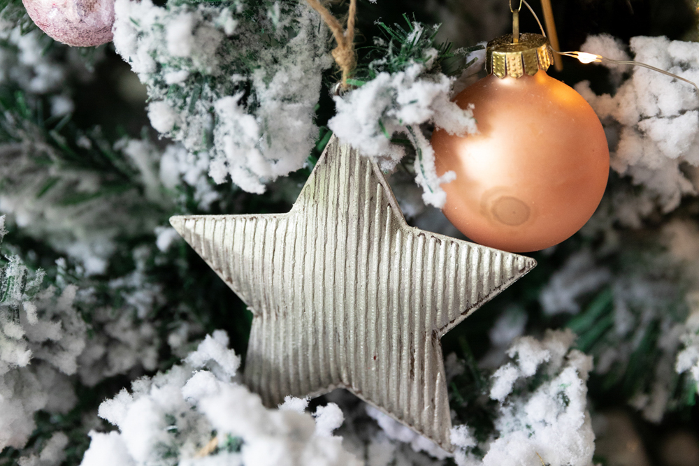 A star-shaped Christmas ornament on the tree