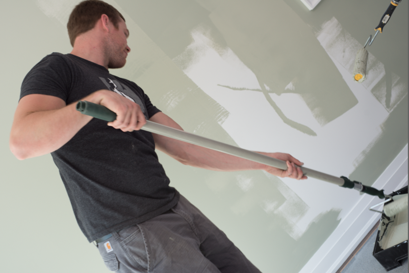 Mike Holmes Jr. painting a wall