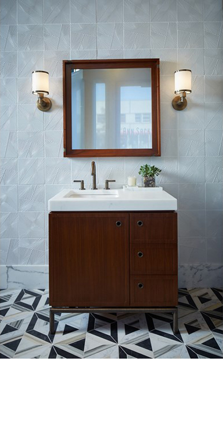 Modern bathroom with geometric floor tiles.