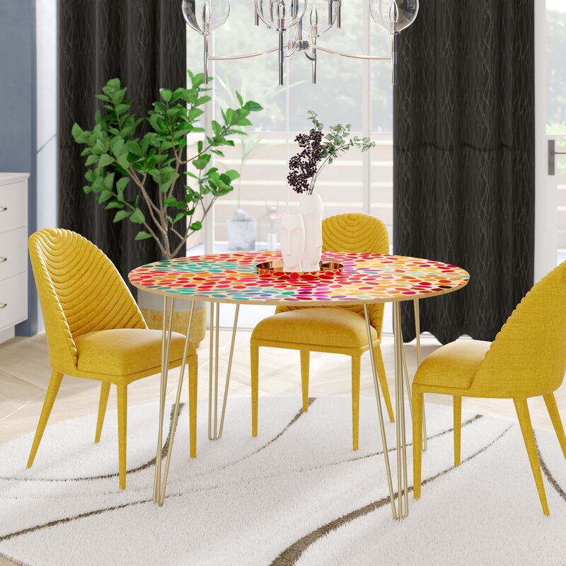 Colourful table with yellow chairs in dining room