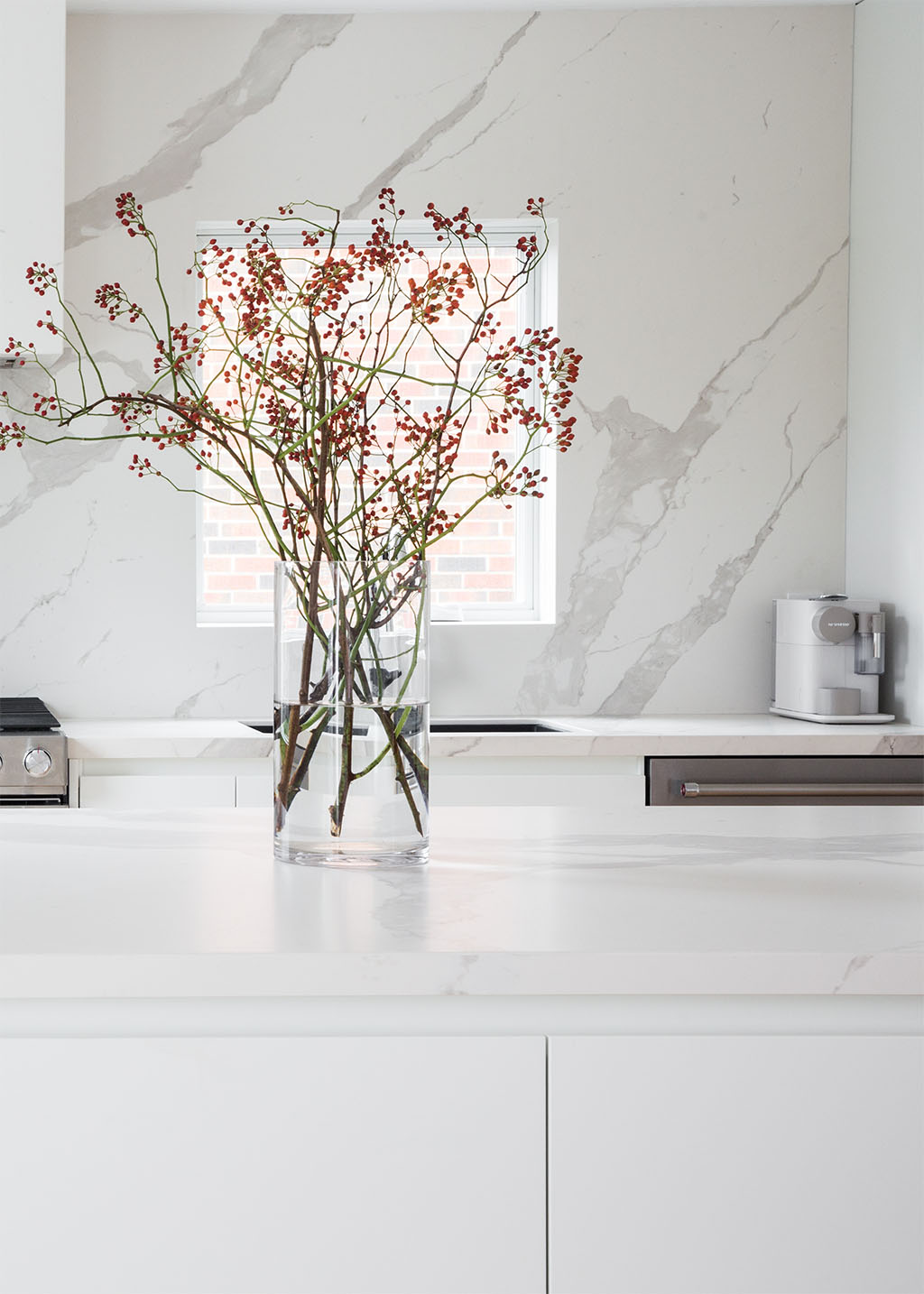 White kitchen countertop with glass vase filled with flowers