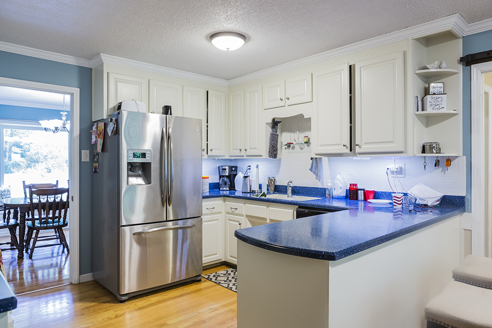 An old kitchen with tacky blue counter tops