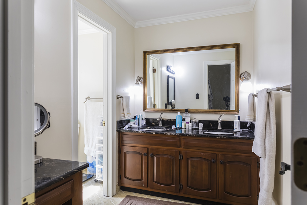 A master bathroom with a brown vanity