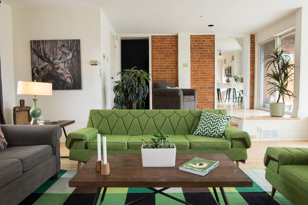 Modern living room with bright hits of green.