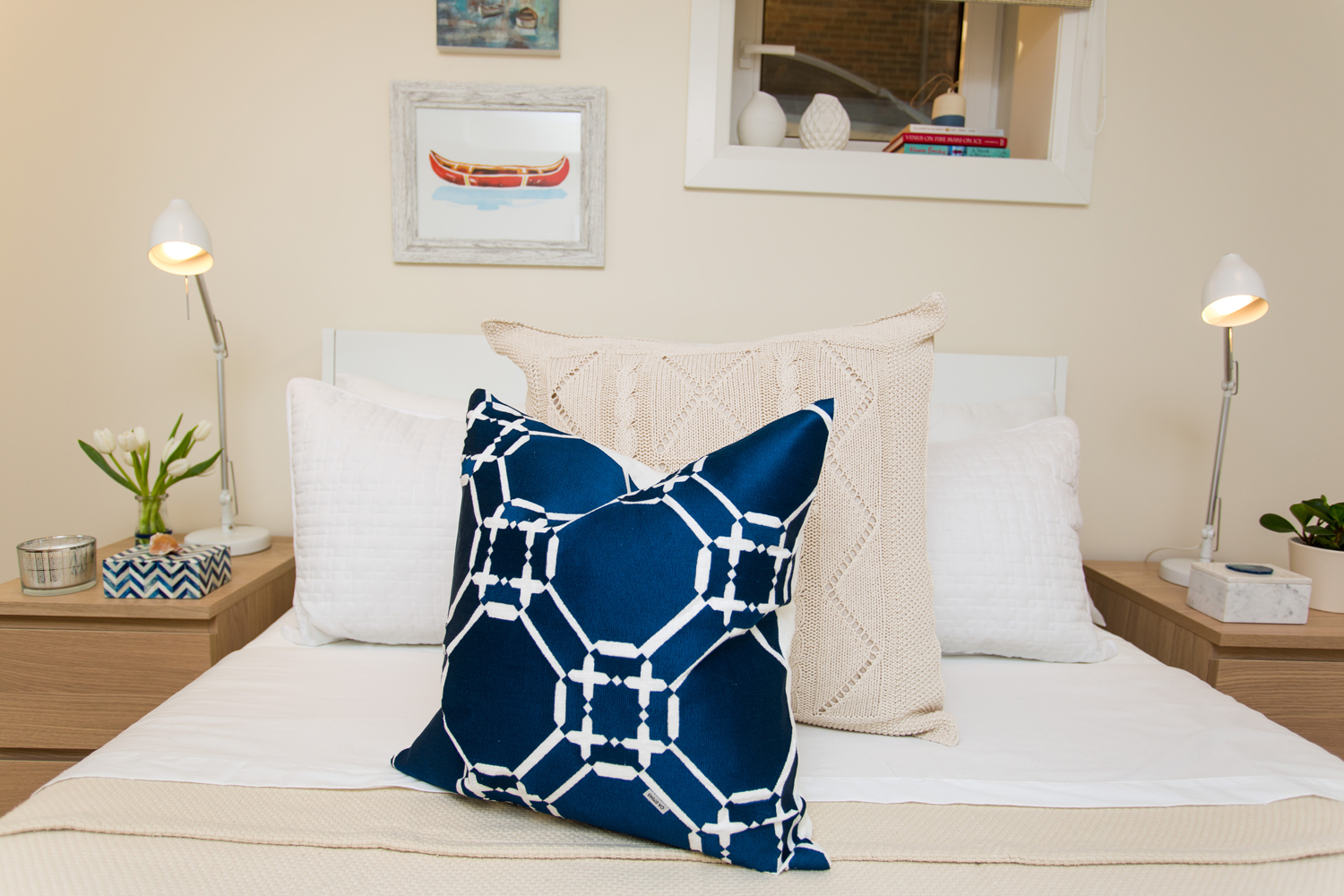 Bright blue printed pillow on cream bedding