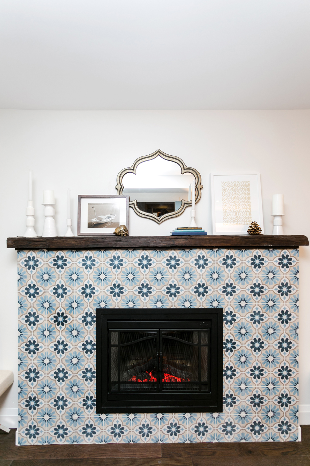 Intricate blue tile around a gas fireplace
