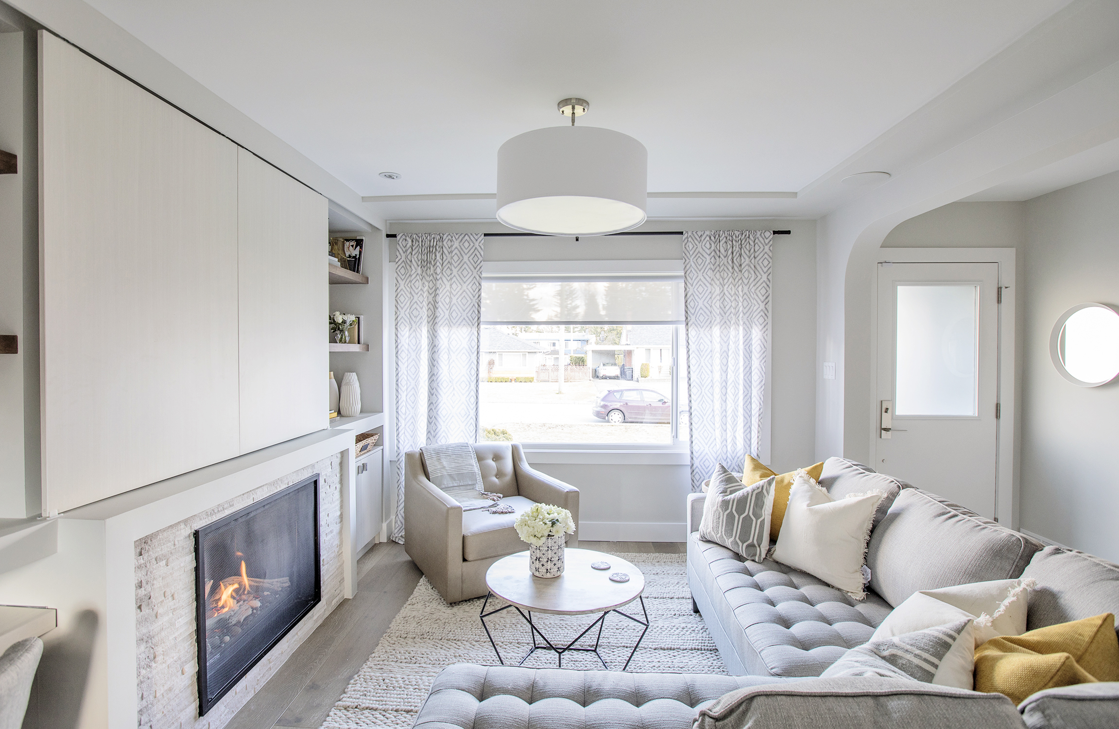 grey living room with yellow accents designed by Jillian Harris